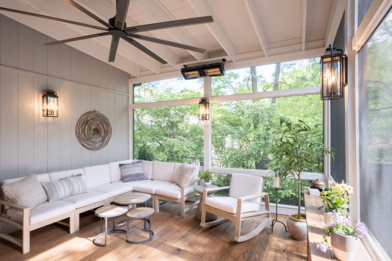 The cozy corner of the screen porch with full view of the surrounding greenery.