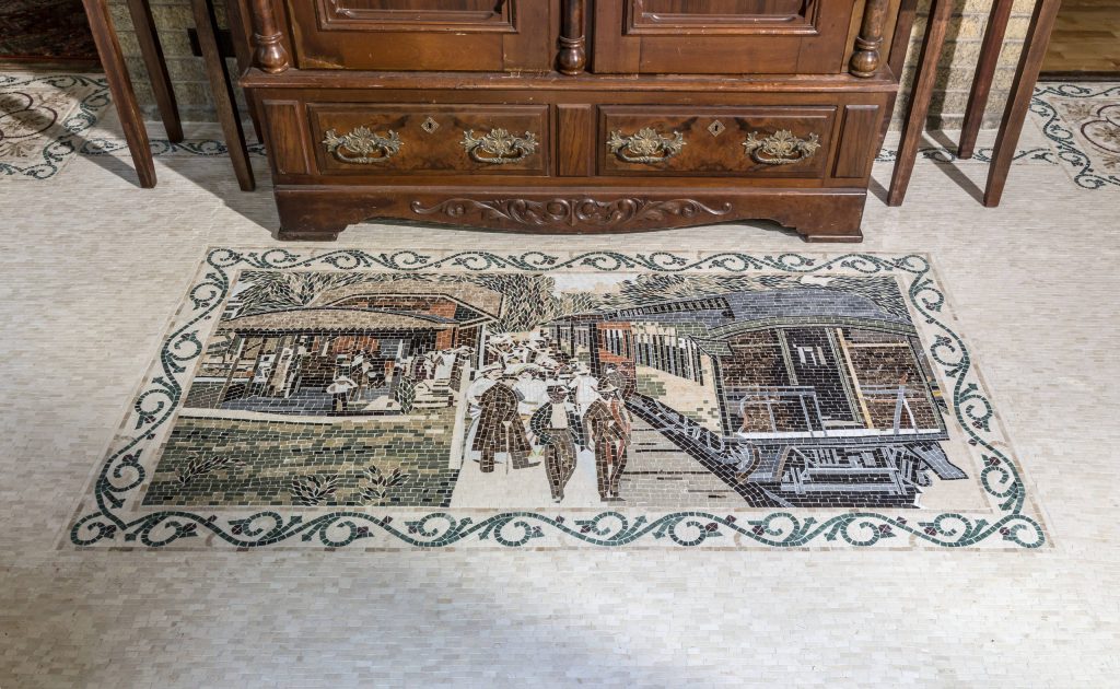The custom tiled floor scene is reminiscent of the original owner’s role as President of the Erie Railroad in the early 1900’s.