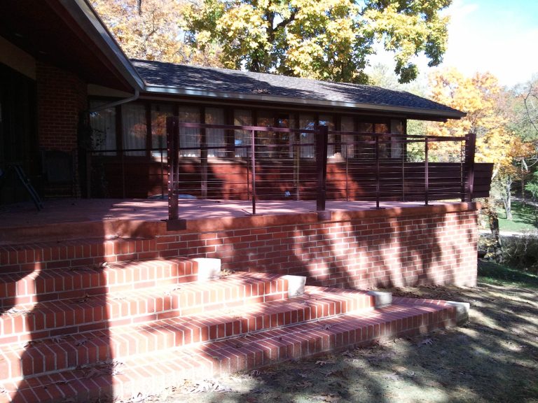 The deteriorated colored concrete patio was removed and rebuilt to the original specifications. A new rail highlights the homes horizontal lines without impeding the view from the patio. by Silent Rivers Design+Build | Outdoor Photos | Porch | Landscaping | Landscape Design | Outdoor Living Space | Porch Design Ideas | Outdoor Living Space Ideas | Backyard Design