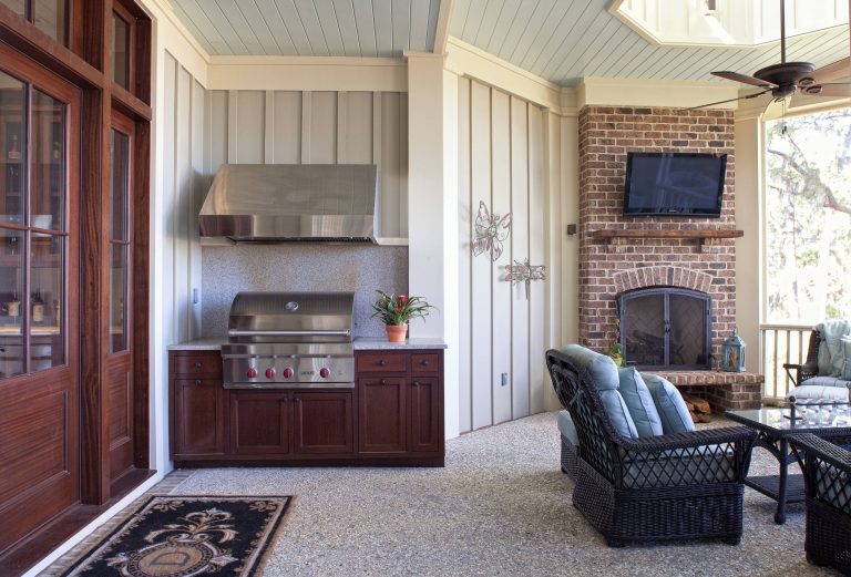 The grilling station, situated beside a cozy sitting area, all centers around the outdoor fireplace.