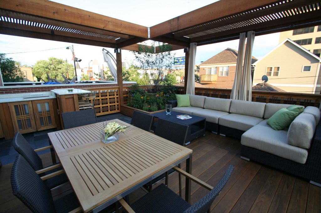 The heavy pergola is a protective element, anchoring the site.