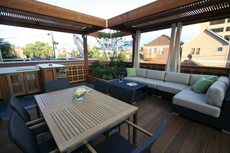 The heavy pergola is a protective element, anchoring the site.