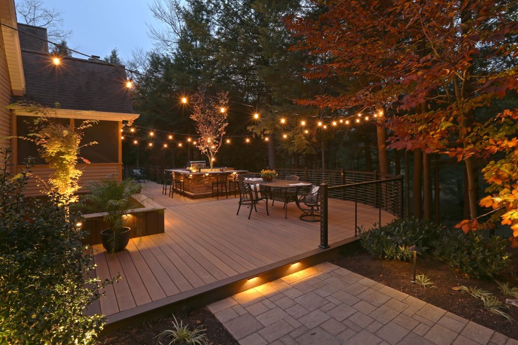 The homeowners wanted an integrated, open outdoor space for entertainment and grilling. It had to look great from the inside of their home and offer the feel of a private wooded retreat; yet be functional.