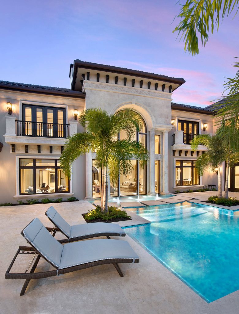 The infinity-edge swimming pool, which measures 40 by 60 feet, was designed so that water flows toward a crackling fire pit in this complete backyard entetainment space.