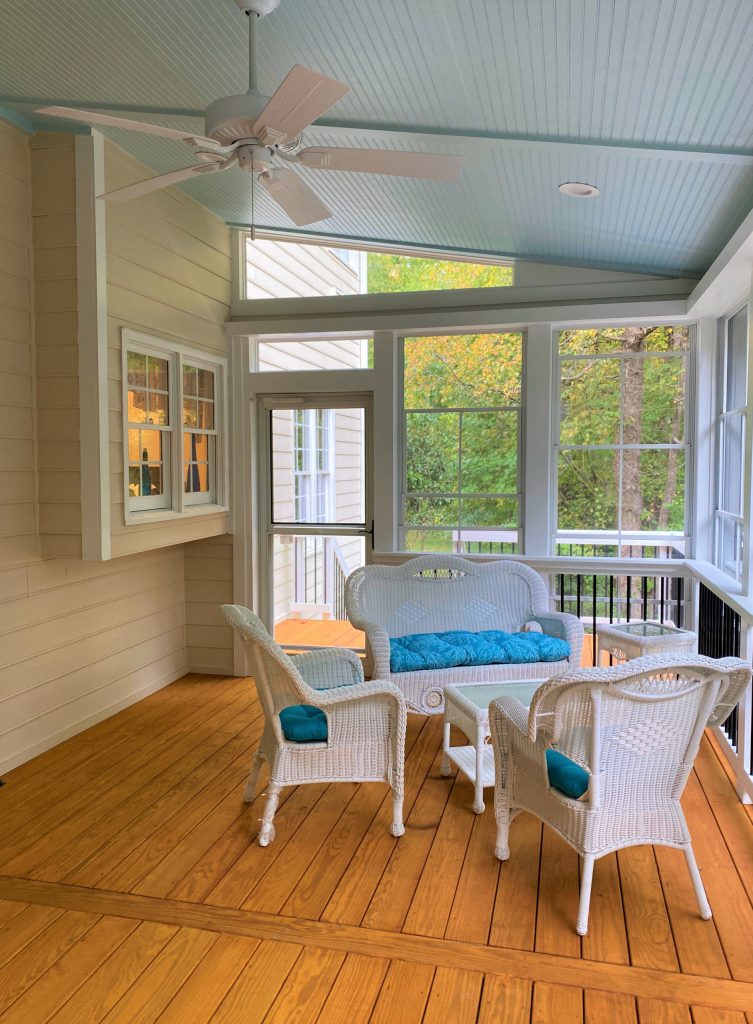 The interior view of this three-season room offers a glimpse of the joyful vibe an enclosed porch can provide any homeowner.