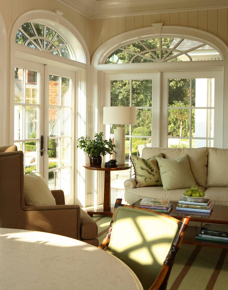 The inviting traditional sunroom in an Atlanta residence by Robert Brown Interior Design.