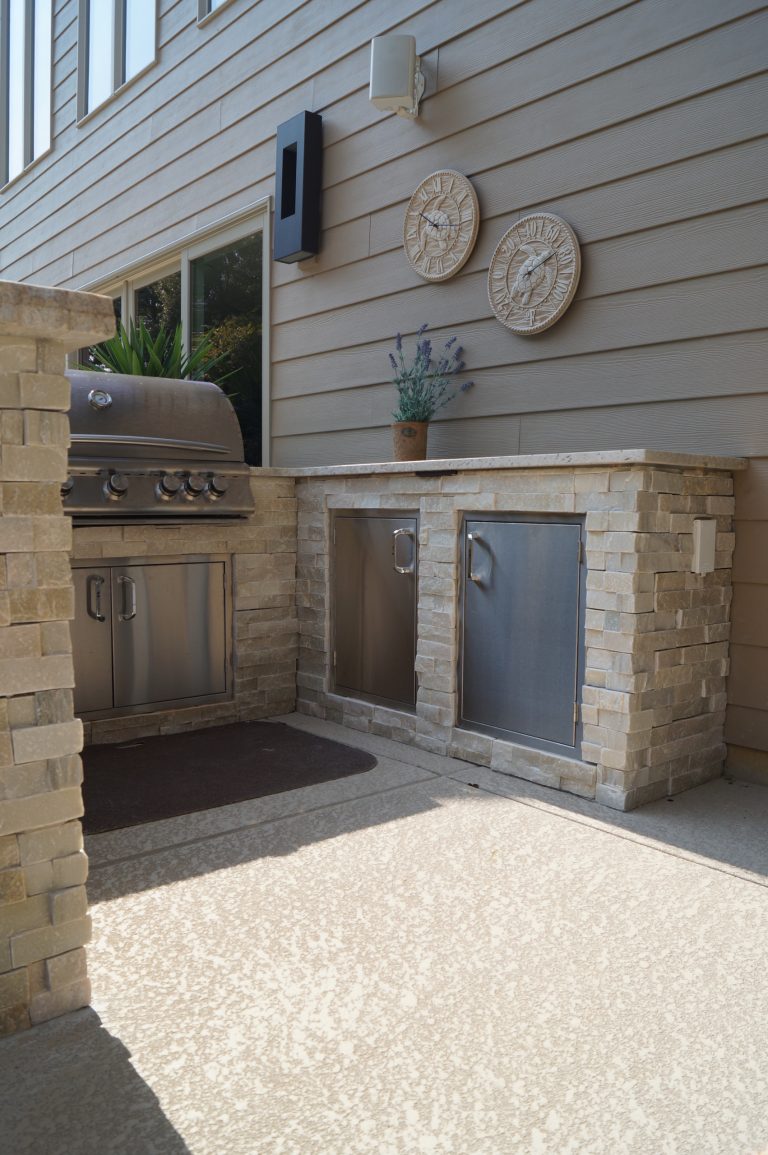 The light colored stone and granite complement the existing materials of the space | Green Guys