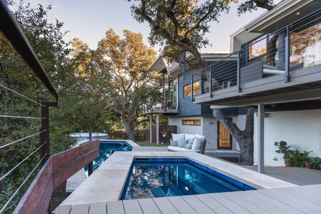 The modern multi-level pool runs along the back of the house along the deck, creating lots of outdoor living and entertaining space. Photo: Ryan Farnau