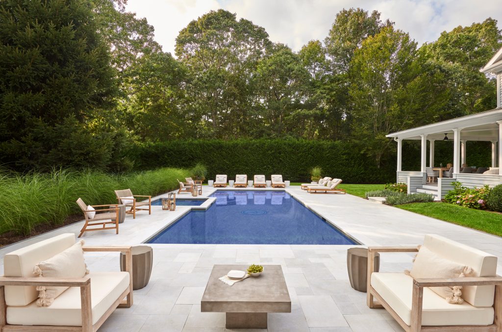 The original pool was replaced with a new gunite pool, which is surrounded by a French patterned stone. Multiple seating areas make it perfect for hosting.