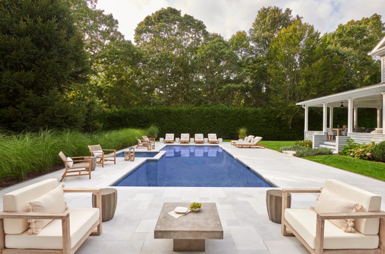 The original pool was replaced with a new gunite pool, which is surrounded by a French patterned stone. Multiple seating areas make it perfect for hosting.