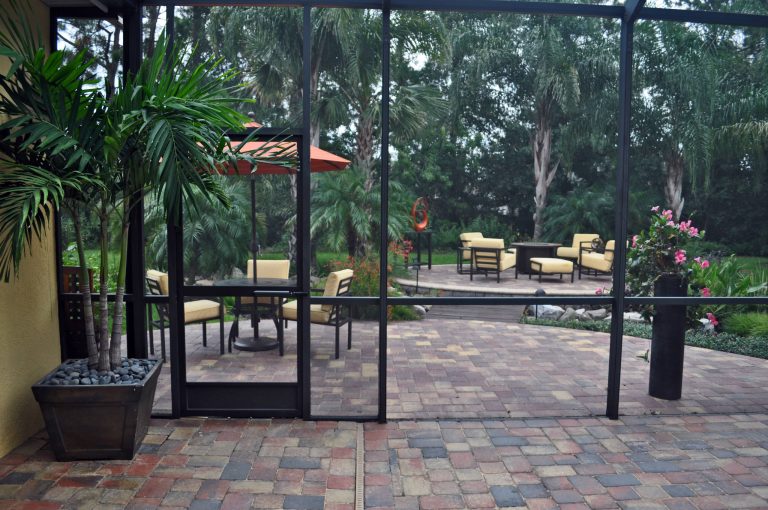 The pavers used to end at the straight edge of the screened enclosure. We now can carry your eyes and your mind outward to the yard that is calling you by name.