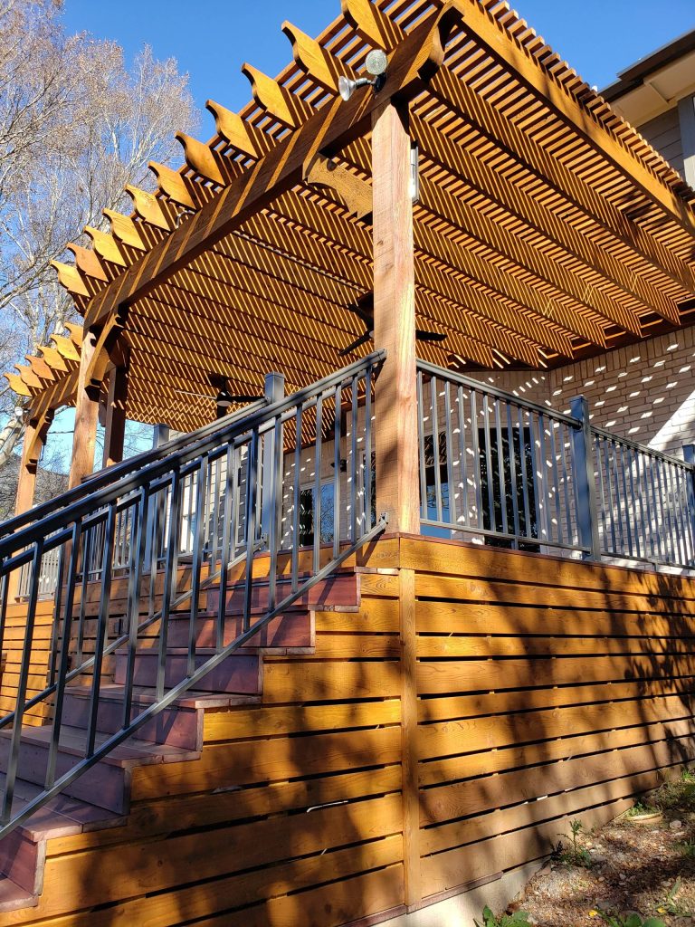 The pergola over the upper deck is built with cedar, and the skirting around the upper deck is cedar, too. For the skirting around the pool deck we used Hardieboard.