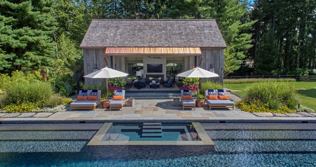 The pool features a submerged spa and gradual entry platforms. Robert Benson Photography.