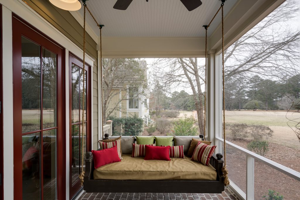 The screened in back porch offers a more private retreat, to enjoy the outdoors and great view. Whether grilling, reading, taking a nap on the gorgeous swing, this will be a favorite space.. by Coastal Signature Homes | Outdoor Photos | Porch | Landscaping | Landscape Design | Outdoor Living Space | Porch Design Ideas | Outdoor Living Space Ideas | Backyard Design