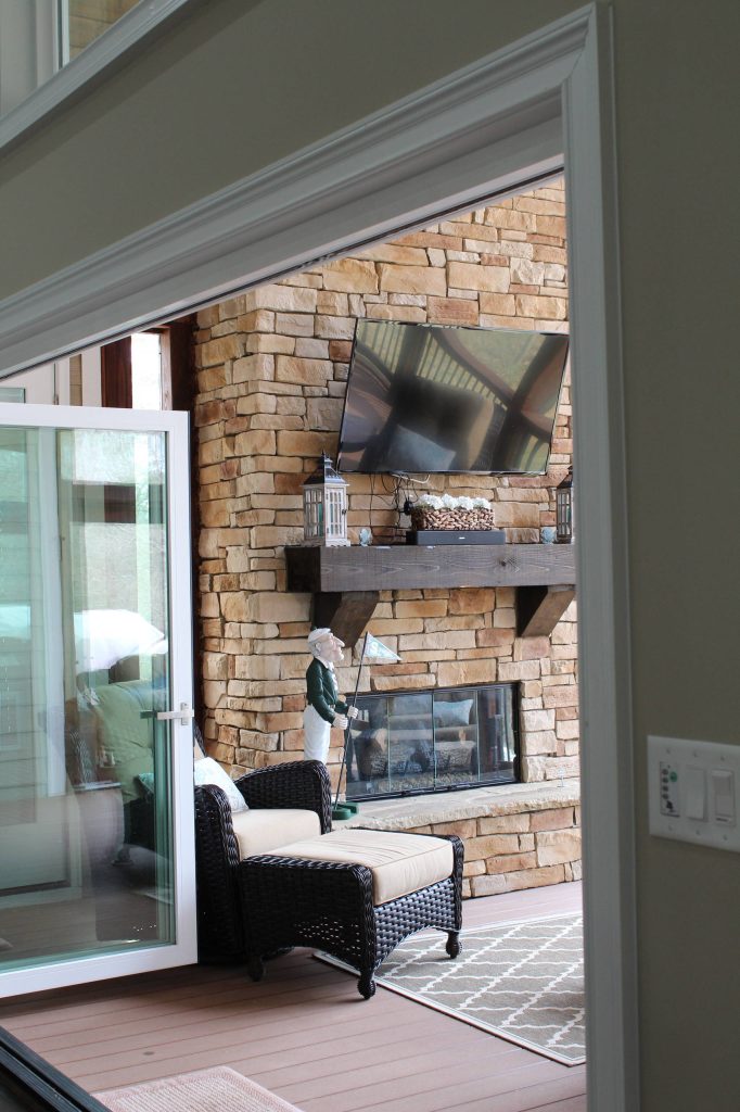 The screened-in porch features a stone fireplace and wonderful views of the lake.