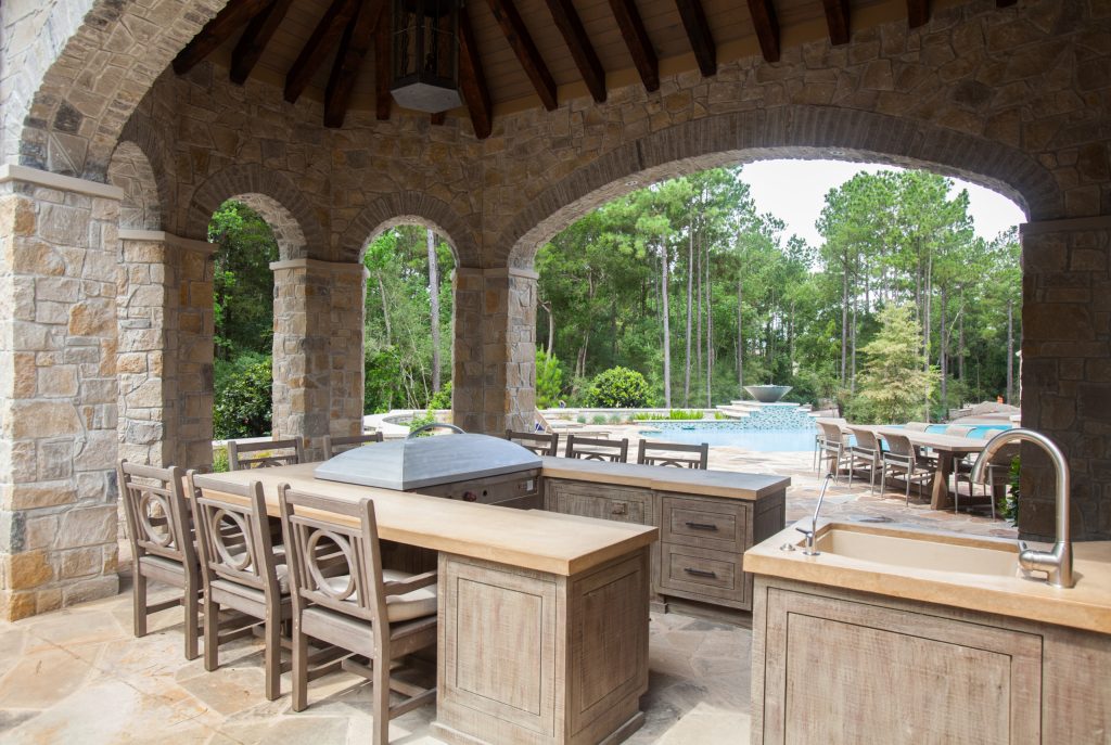 The u-shaped island with built-in grill allows the cook to stay at the center of the action. Guests can gather around and watch the meal preparations.

Photos by: Julie Soefer by Slovack-Bass | Outdoor Kitchens | Backyard Design | Outdoor Living Spaces | Landscape Design