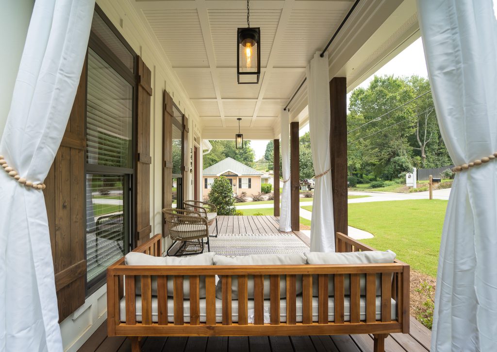 The welcoming Front Covered Porch of The Catilina. View House Plan THD-5289: https://www.thehousedesigners.com/plan/catilina-1013-5289/ by The House Designers | Outdoor Photos | Porch | Landscaping | Landscape Design | Outdoor Living Space | Porch Design Ideas | Outdoor Living Space Ideas | Backyard Design