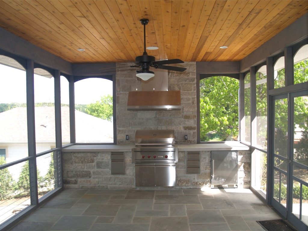 There is a large screen porch with a built-in outdoor kitchen.