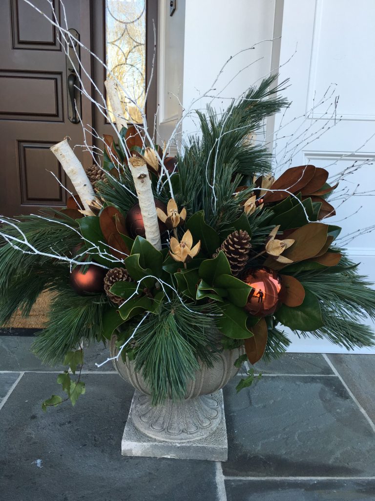 These urns are filled with winter greens, magnolia boughs, white birch branches, and touches of copper for a different take on Christmas decorations. by Cording Landscape Design | Outdoor Photos | Porch | Landscaping | Landscape Design | Outdoor Living Space | Porch Design Ideas | Outdoor Living Space Ideas | Backyard Design