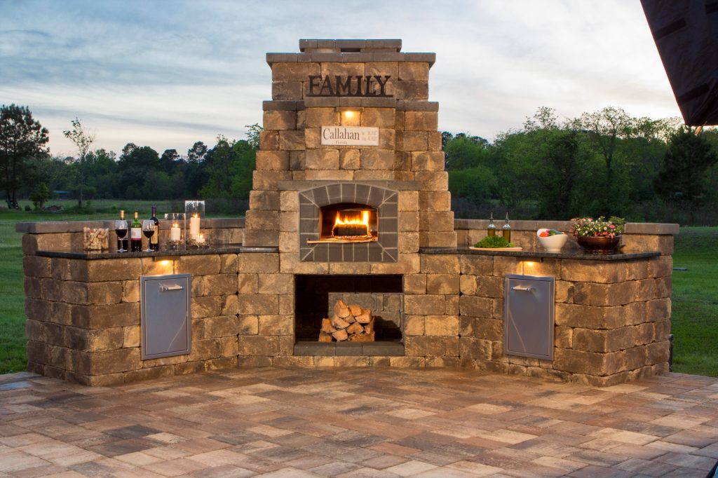 This Callahan backyard kitchen features an outdoor brick oven for baking pizza.