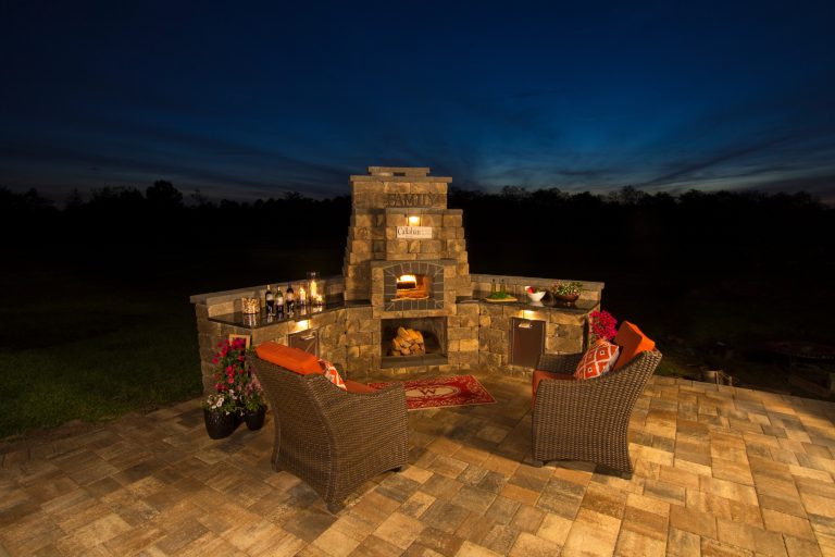 This Callahan backyard kitchen features an outdoor brick oven for baking pizza.