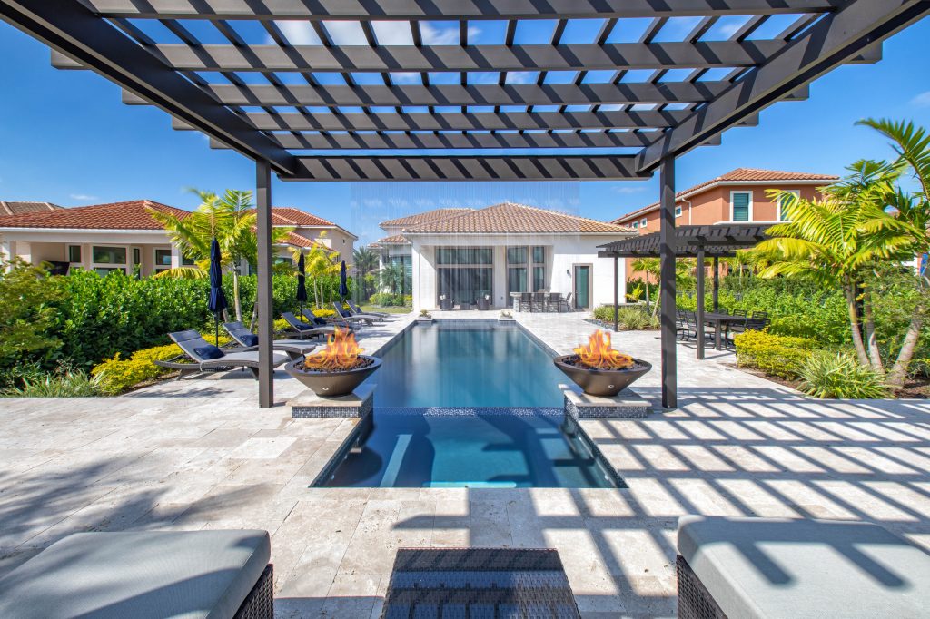 This amazing custom pool and spa in Parkland has 2 seating areas, raised spa and rain pergola providing crisp water sounds!