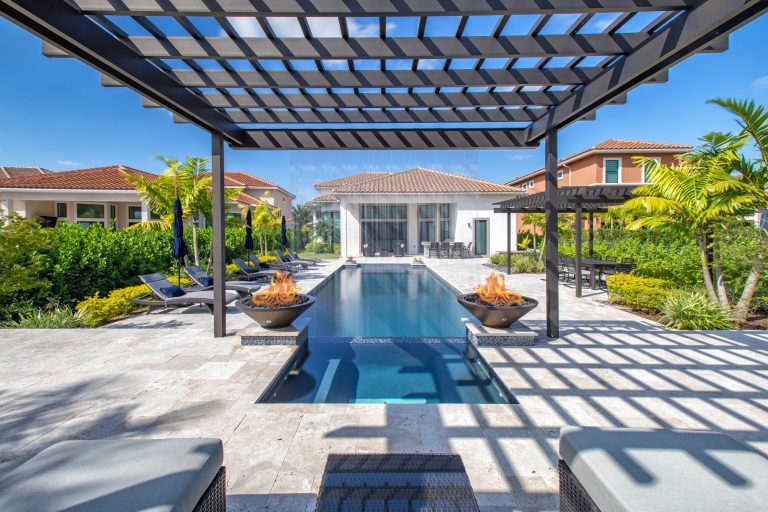 This amazing custom pool and spa in Parkland has 2 seating areas, raised spa and rain pergola providing crisp water sounds!