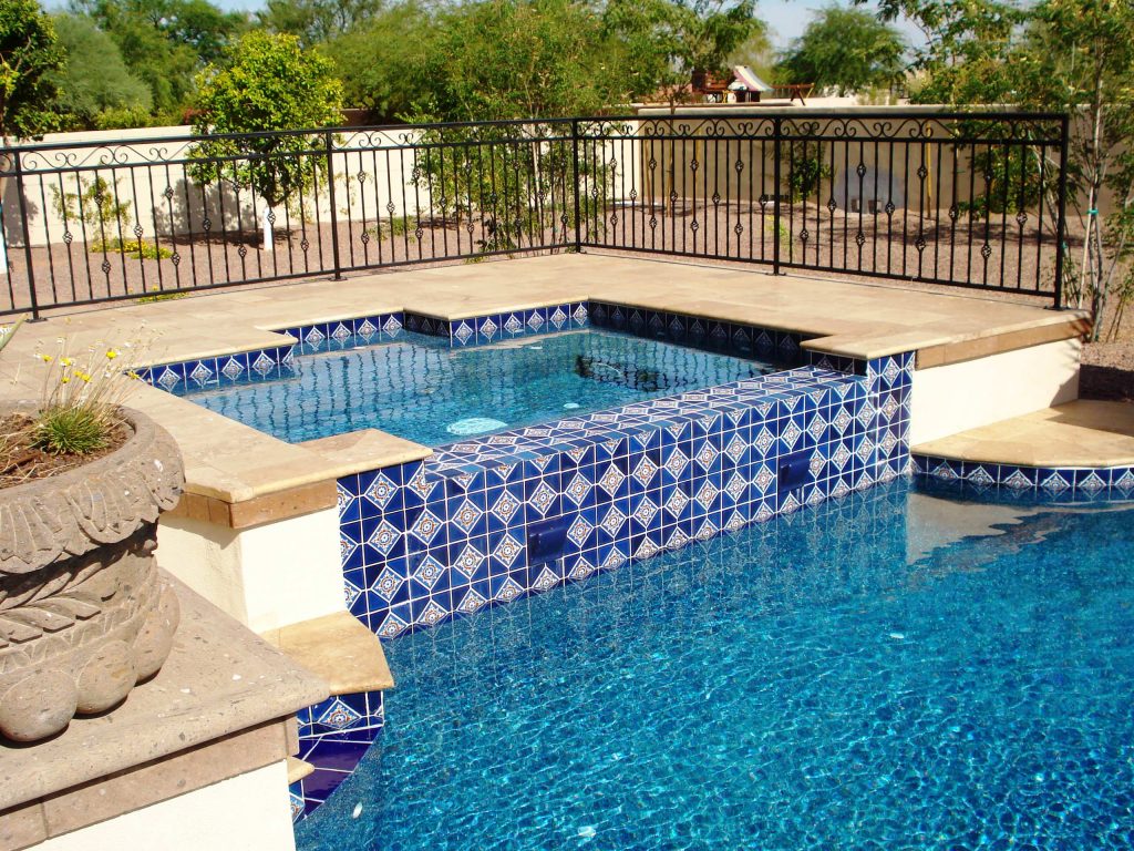 This beautiful Mediterranean style spa has a large geometric shape featuring beautiful tile work and a negative edge. See more at www.shastapools.com.