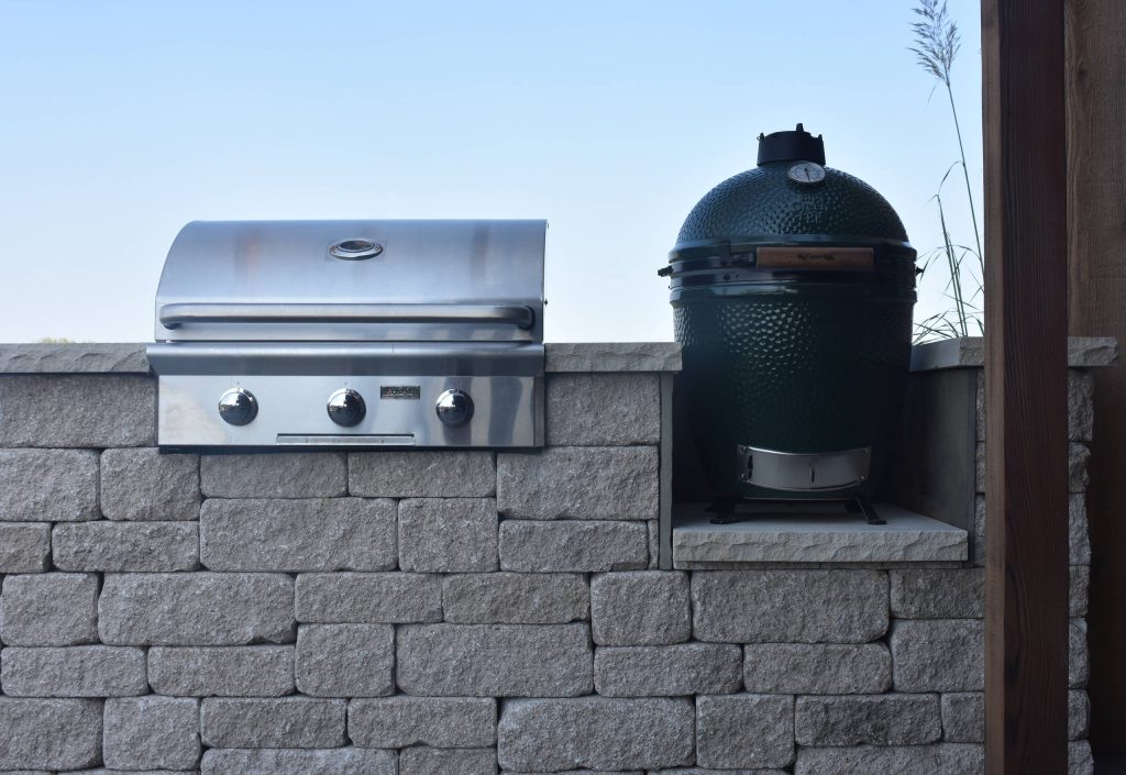 This beautiful Versa-Lok outdoor kitchen features a gas grill, smoker, and built-in sink for easy clean up.
