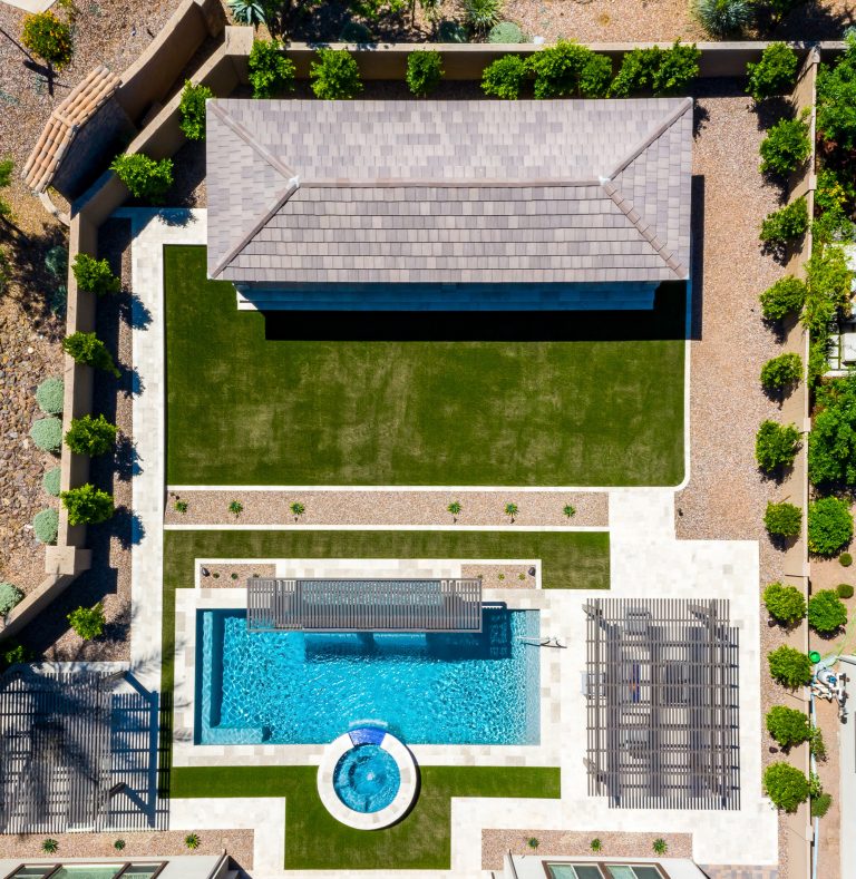 This beautiful backyard has it all: custom spa, beautiful pool, full outdoor kitchen, plenty of space to lounge, and a grass area big enough to play lawn games!