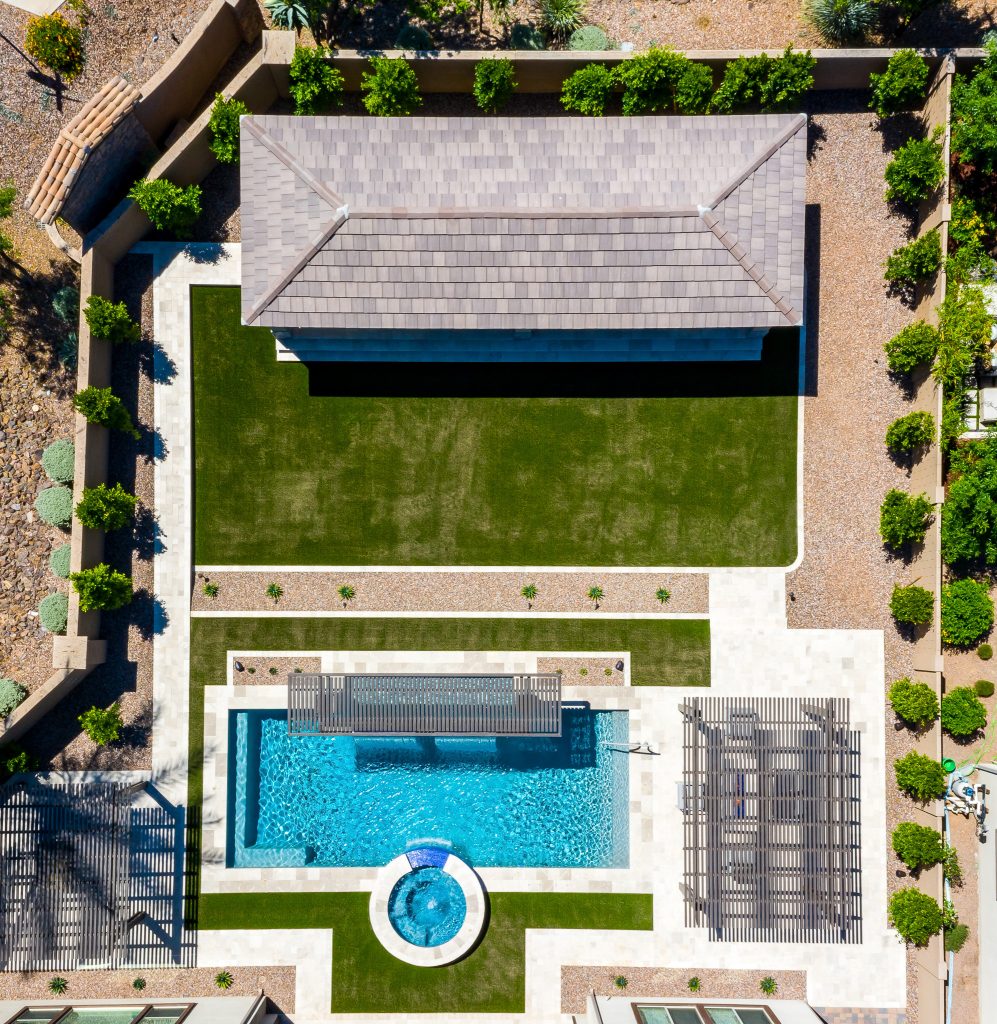 This beautiful backyard has it all: custom spa, beautiful pool, full outdoor kitchen, plenty of space to lounge, and a grass area big enough to play lawn games!