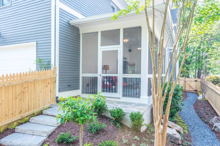 This beautiful, bright screened-in porch is a natural extension of this Atlanta home. With high ceilings and a natural stone stairway leading to the backyard, this porch is the perfect addition for summer. by Harbour Towne Construction | Outdoor Photos | Porch | Landscaping | Landscape Design | Outdoor Living Space | Porch Design Ideas | Outdoor Living Space Ideas | Backyard Design