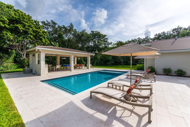 This expansive patio makes for plenty of poolside entertainment area.


Photo by Justin Namon @ ra-haus fotografie
Example of a large trendy backyard stone patio kitchen design in Miami with a gazebo
by Debowsky Design Group | Outdoor Kitchens | Backyard Design | Outdoor Living Spaces | Landscape Design