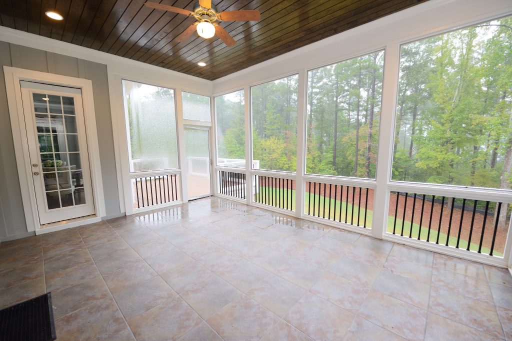 This extra large screen porch is a great place to entertain and enjoy the outdoors. The wood planked ceiling makes for a nice contrast to the tile floor. Photo: M. Eric Honeycutt by Blue Heron Signature Homes | Outdoor Photos | Porch | Landscaping | Landscape Design | Outdoor Living Space | Porch Design Ideas | Outdoor Living Space Ideas | Backyard Design