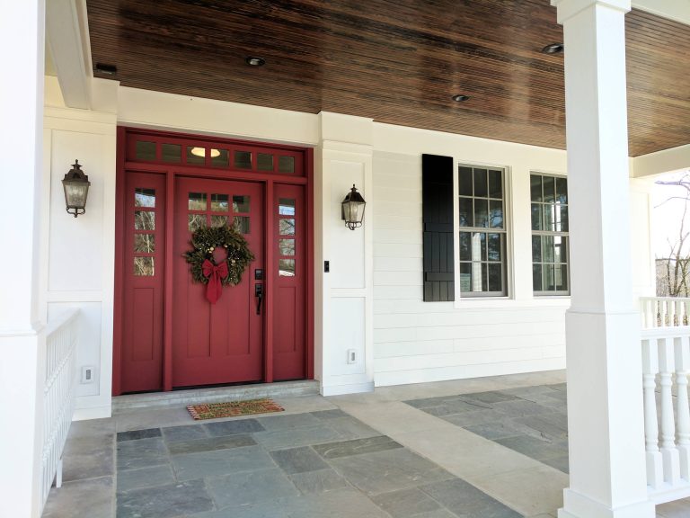 This front porch addition includes a custom-designed front door, custom stone pattern/design, and stained bead-board ceiling.