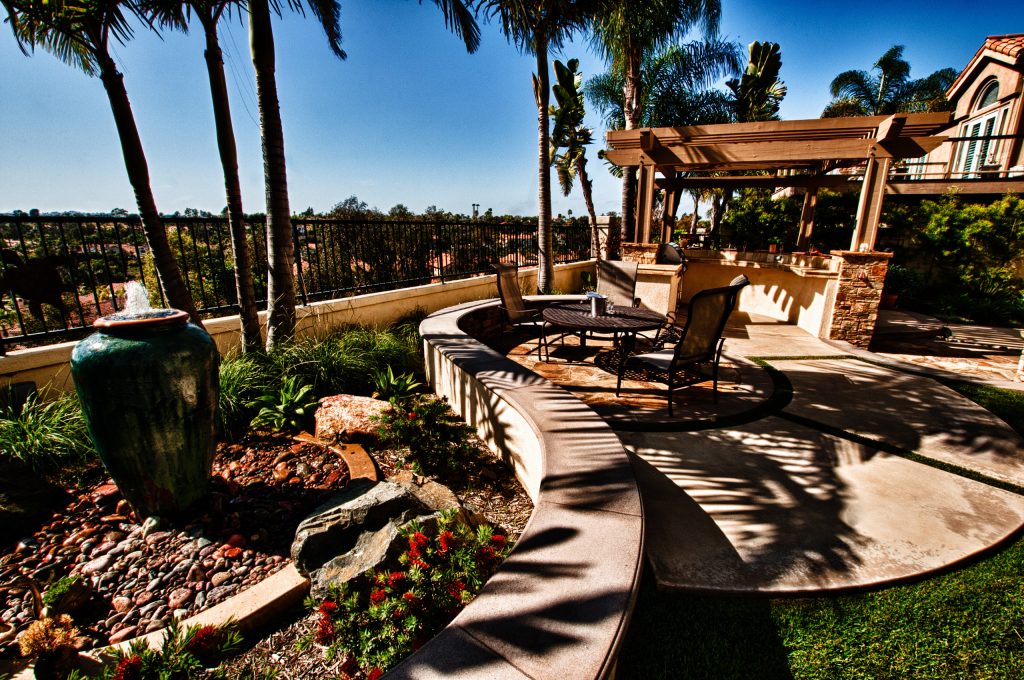 This garden features multiple seating and dining areas and an outdoor kitchen w/ open beam wood pergola. Multiple fountains help to provide auditory and visual interest.
