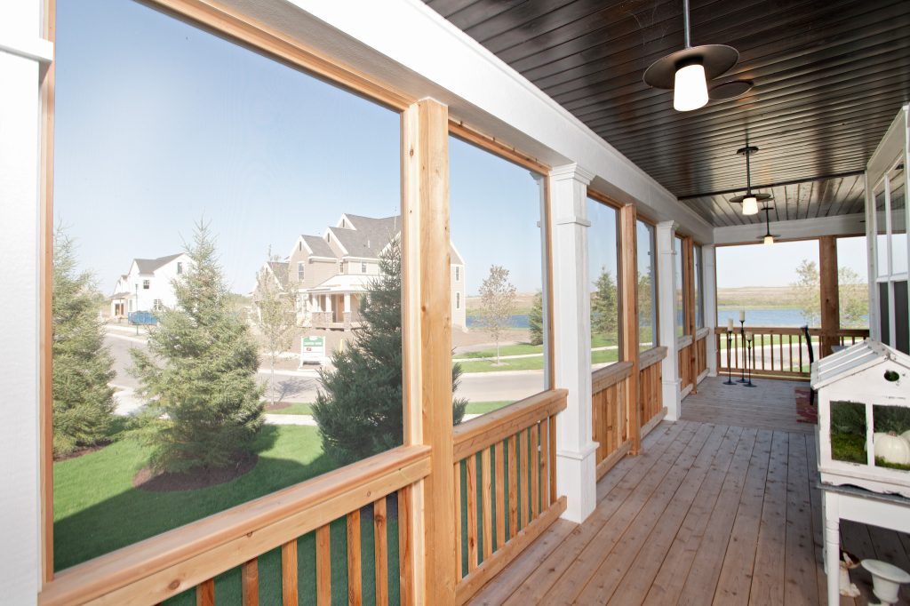 This incredible wrap around screened in porch is the perfect solution to the Minnesota summer mosquitos! Enjoy our highly coveted summer months without the pests! by Homes by Tradition | Outdoor Photos | Porch | Landscaping | Landscape Design | Outdoor Living Space | Porch Design Ideas | Outdoor Living Space Ideas | Backyard Design