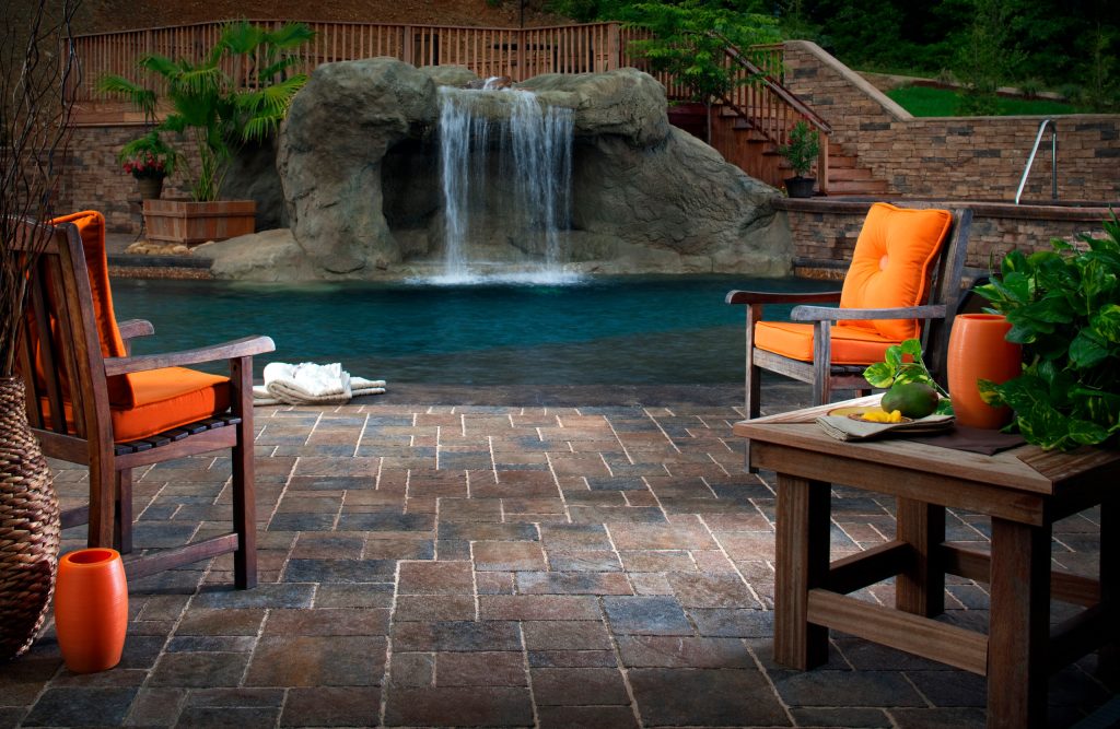 This is a Belgard photo featuring a pool side view of their Urbana Pavers.