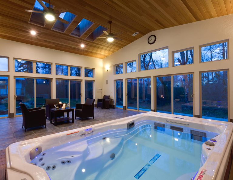 This is a Swim spa room addition with a sunken swim spa and composite swim deck around the spa for drainage. Tile floors and clear cedar ceiling.