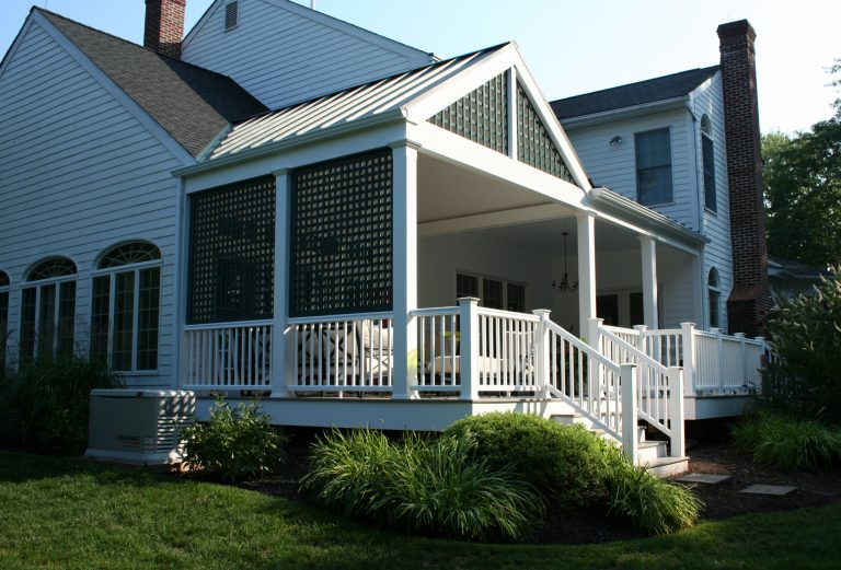 This is a covered porch addition done in a classic cottage style, with beadboard details and lattice work.