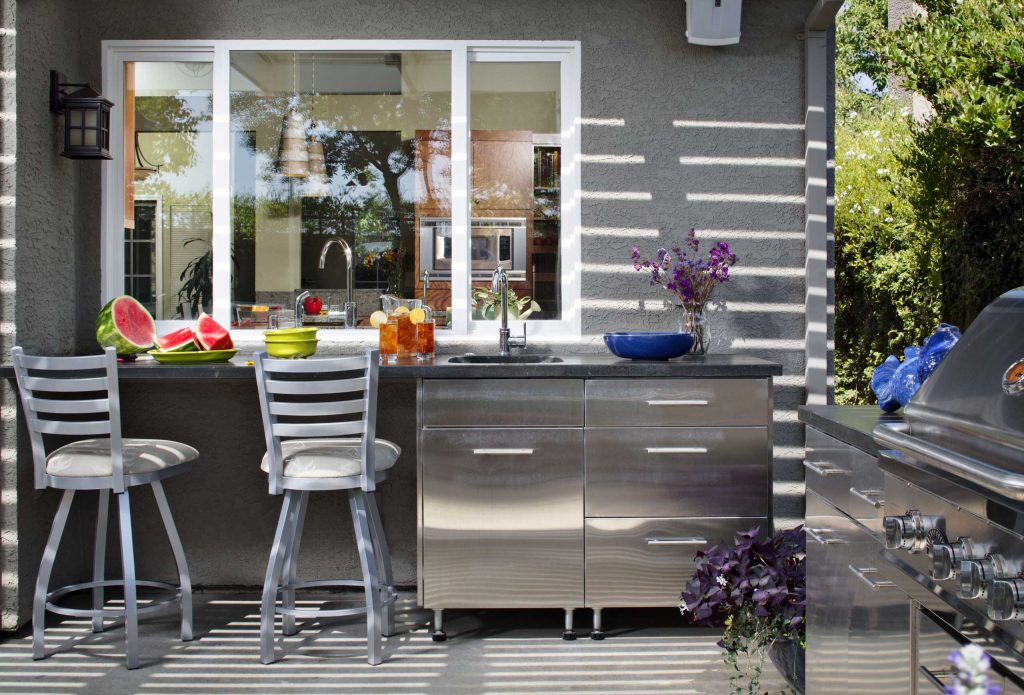 This is a great place for the kids projects. Inside is the main kitchen sink, outside is a handy outdoor sink. Things can be passed through the slider windows. Chipper Hatter Photography by The Home Improvements Group, Inc. | Outdoor Kitchens | Backyard Design | Outdoor Living Spaces | Landscape Design
