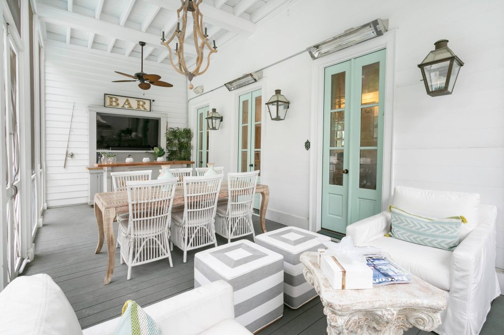 This is an example of a coastal porch design in Charleston with decking and a roof extension. by Charleston Home + Design Mag | Outdoor Photos | Porch | Landscaping | Landscape Design | Outdoor Living Space | Porch Design Ideas | Outdoor Living Space Ideas | Backyard Design