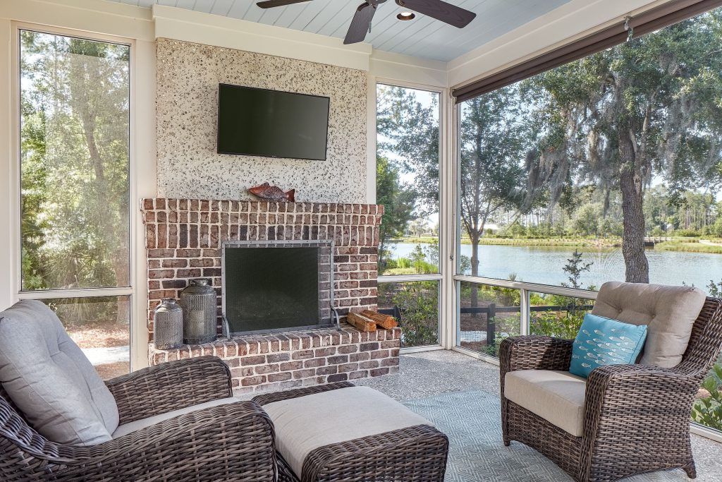 This is an example of a coastal screened-in porch design in Other with a roof extension. by Resort Custom Homes | Outdoor Photos | Porch | Landscaping | Landscape Design | Outdoor Living Space | Porch Design Ideas | Outdoor Living Space Ideas | Backyard Design