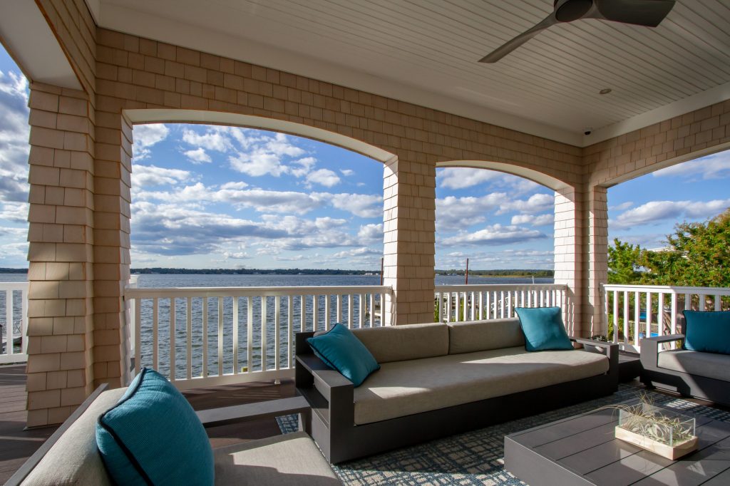 This is an example of a coastal wood railing porch design in New York with a roof extension. by HK Interiors, llc | Outdoor Photos | Porch | Landscaping | Landscape Design | Outdoor Living Space | Porch Design Ideas | Outdoor Living Space Ideas | Backyard Design