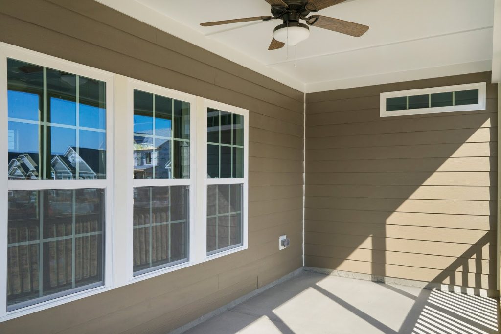 This is an example of a concrete screened-in side porch design in Raleigh with a roof extension. by Royal Oaks Homes | Outdoor Photos | Porch | Landscaping | Landscape Design | Outdoor Living Space | Porch Design Ideas | Outdoor Living Space Ideas | Backyard Design