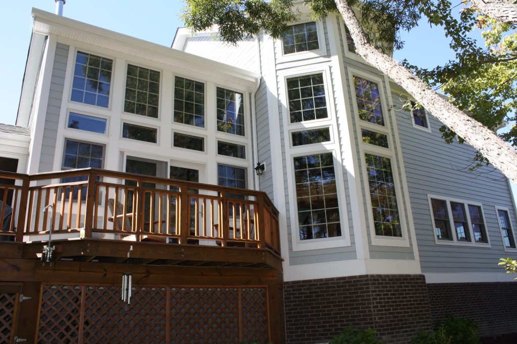 This is an example of a contemporary wood railing back porch design in Other with decking. by Premiere Contracting Inc. | Outdoor Photos | Porch | Landscaping | Landscape Design | Outdoor Living Space | Porch Design Ideas | Outdoor Living Space Ideas | Backyard Design