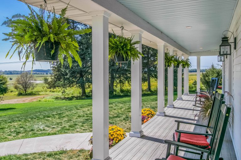 This is an example of a country front porch design in Cedar Rapids with decking and a roof extension. by Gary Frakes Construction | Outdoor Photos | Porch | Landscaping | Landscape Design | Outdoor Living Space | Porch Design Ideas | Outdoor Living Space Ideas | Backyard Design