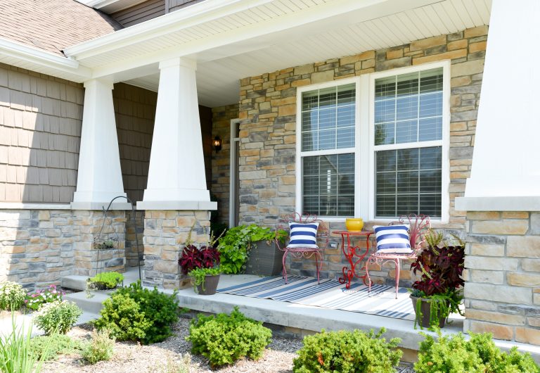 This is an example of a craftsman stone front porch design in Detroit with a roof extension. by HRS Communities | Outdoor Photos | Porch | Landscaping | Landscape Design | Outdoor Living Space | Porch Design Ideas | Outdoor Living Space Ideas | Backyard Design