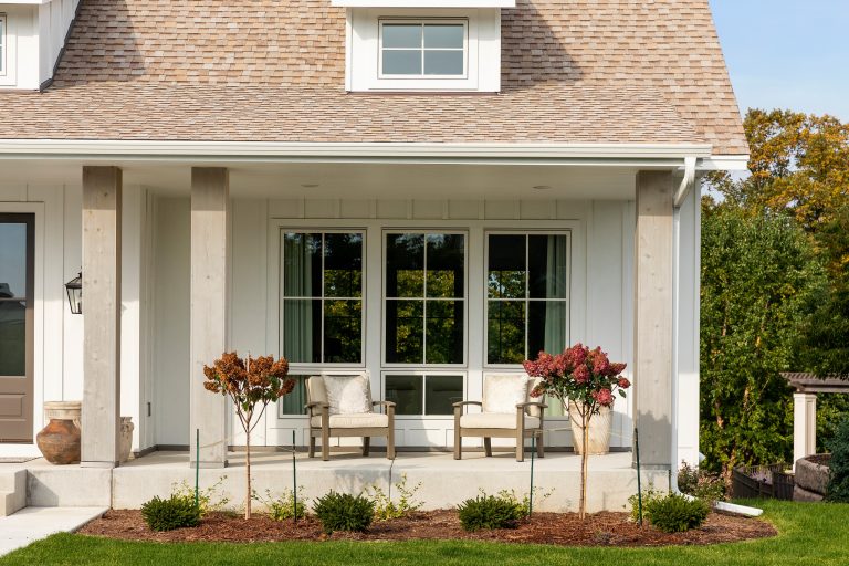 This is an example of a farmhouse concrete porch column design in Minneapolis with a roof extension. by WEST BAY HOMES real estate development | Outdoor Photos | Porch | Landscaping | Landscape Design | Outdoor Living Space | Porch Design Ideas | Outdoor Living Space Ideas | Backyard Design