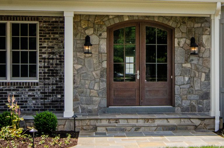 This is an example of a farmhouse stone front porch design in DC Metro with an awning. by Fairhaven Homes | Outdoor Photos | Porch | Landscaping | Landscape Design | Outdoor Living Space | Porch Design Ideas | Outdoor Living Space Ideas | Backyard Design